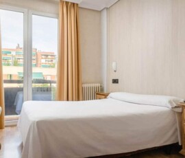 Cómoda habitación de hotel en Madrid Río con balcones y ambiente acogedor.