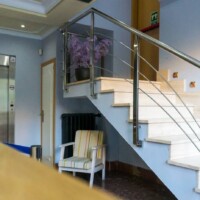 Escaleras modernas y elegantes en el Hotel Madrid Río, cerca del río y con fácil acceso, ideal para huéspedes que buscan comodidad y diseño contemporáneo.